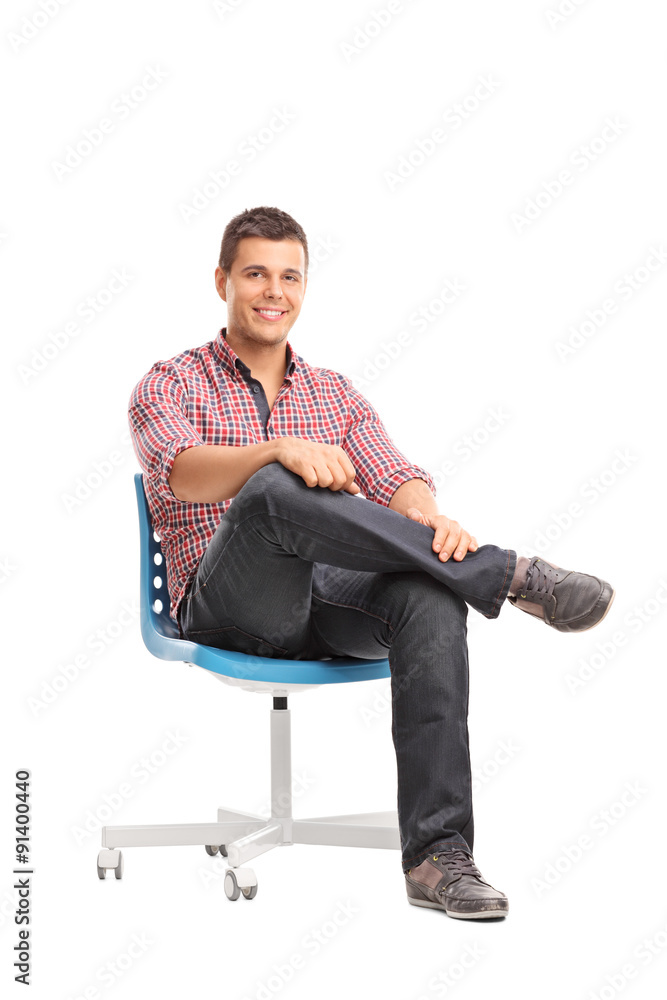 Relaxed young man sitting on a chair Relaxed young man sitting on a chair