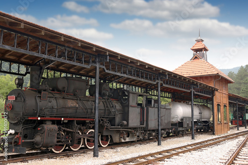 railway station with old steam locomotive