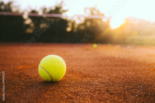 Tennis ball on clay court © yossarian6