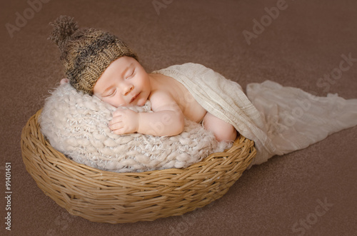 plump baby sleeps in basket