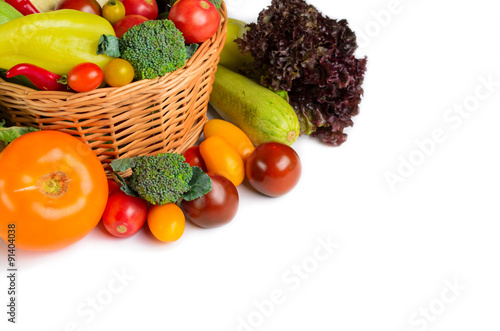 Still life of autumn vegetables in a basket on a white background. Space for text.