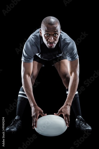 Sportsman holding ball while playing rugby