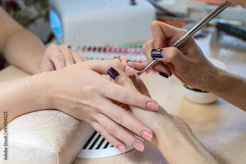 painting nails in nail salon, UV lap of quick dry nail polish ma
