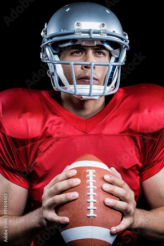 Determined sportsman holding American football