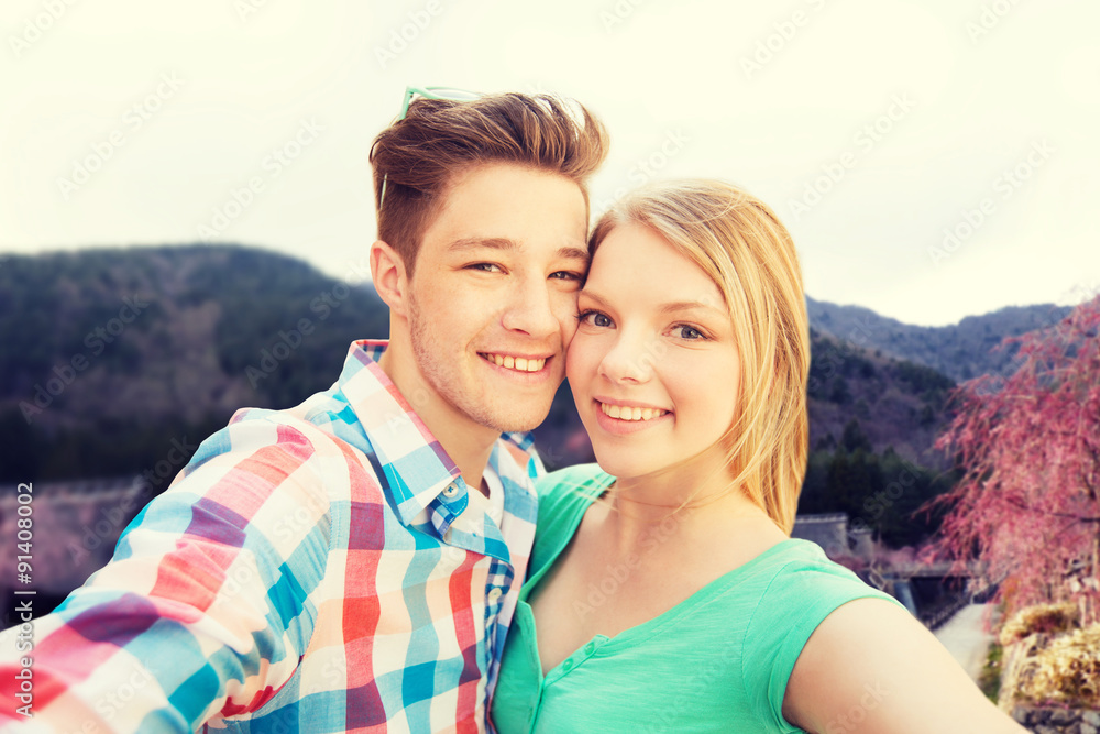 smiling couple taking selfie over asian landscape smiling couple taking selfie over asian landscape