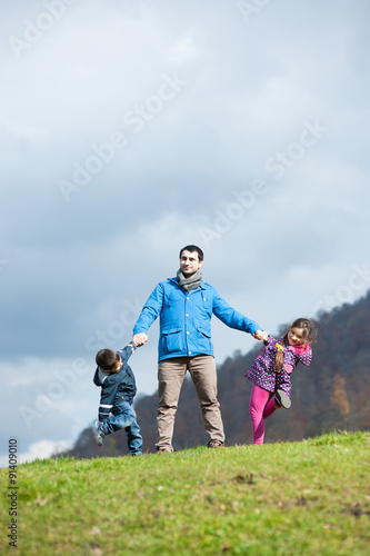father with children in autumn mountains