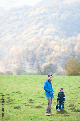 father and son in autumn mountains