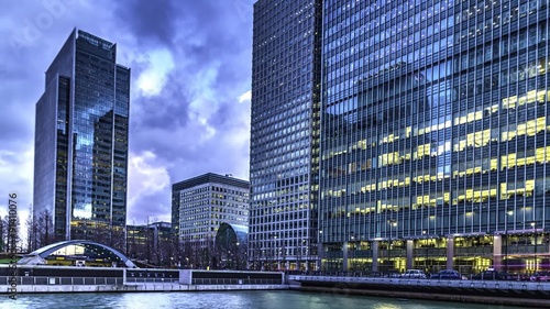 Time lapse of office buildings in Canary Wharf, London. Taken at dusk with transiction into the night. The Dockland has become a major financial centre in London photo