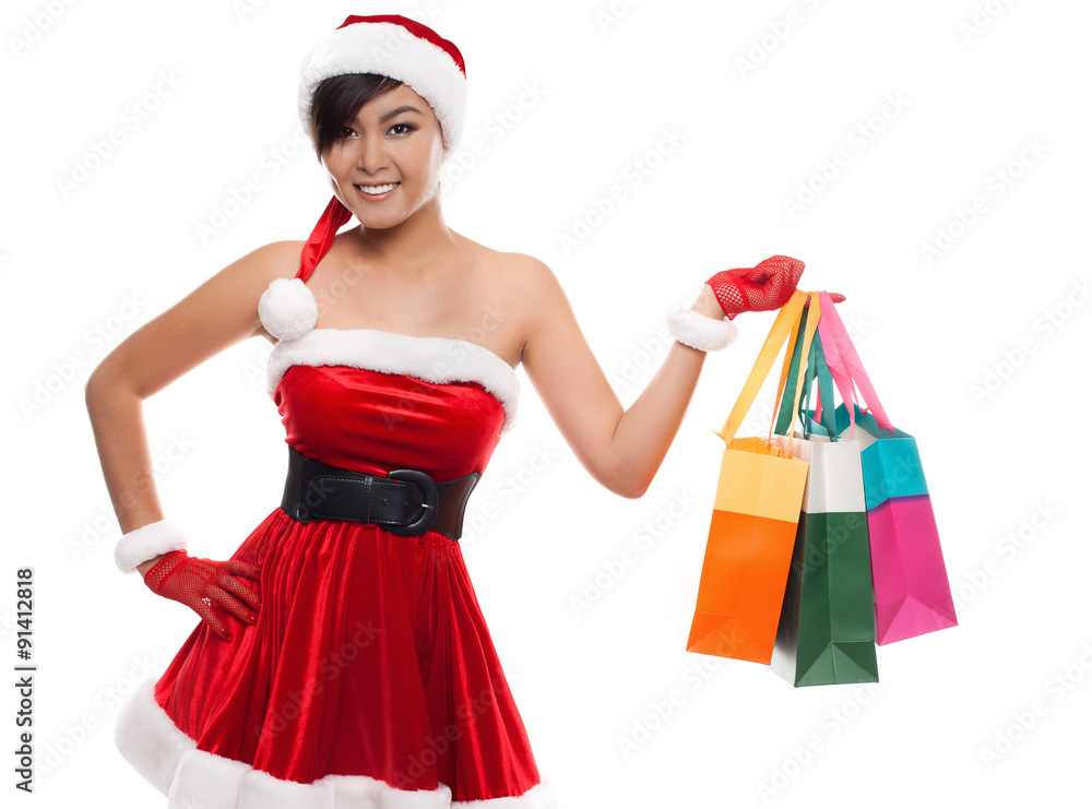 Smiling asian woman in red santa costume with colorful shopping Smiling asian woman in red santa costume with colorful shopping