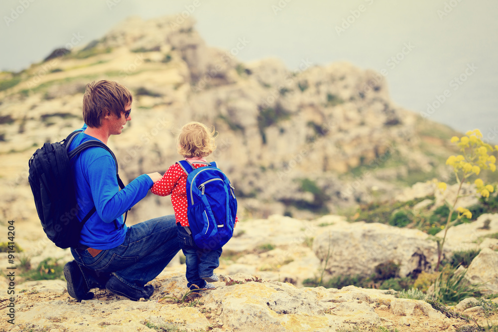 Fototapeta premium father and little daughter hiking in mountains