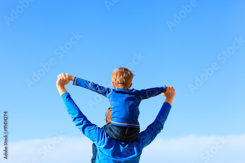 happy father and little son play on sky