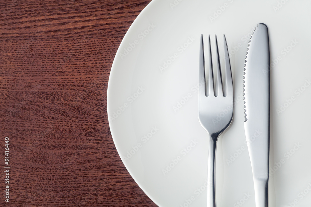 Knife and fork with plate, Close-up. Knife and fork with plate, Close-up.