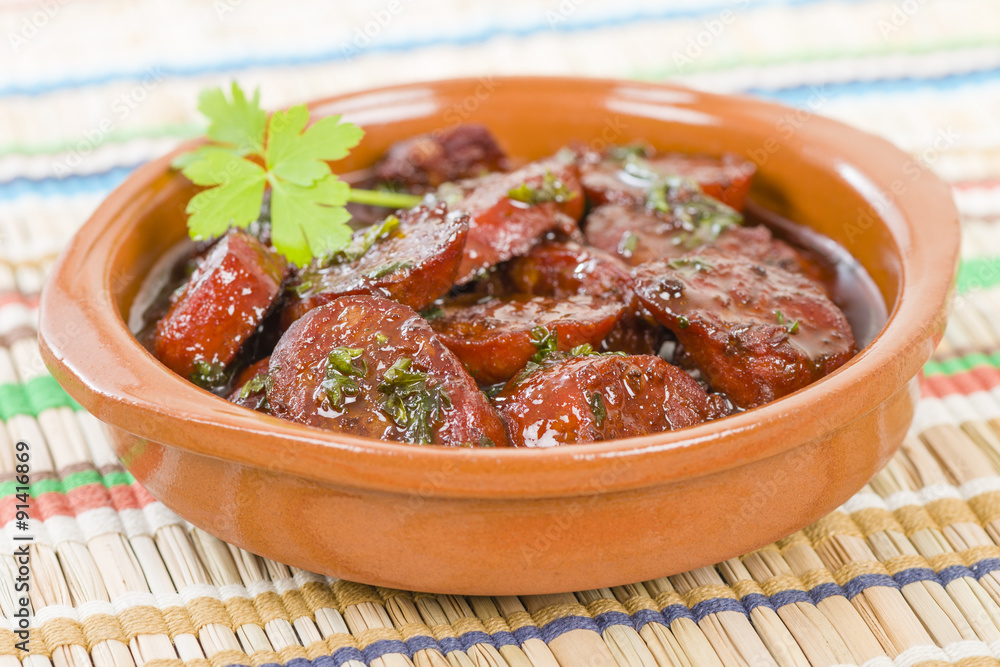 Chorizo al Vino (Spicy sausage cooked in red wine). Traditional Spanish  tapas dish. Stock Photo | Adobe Stock