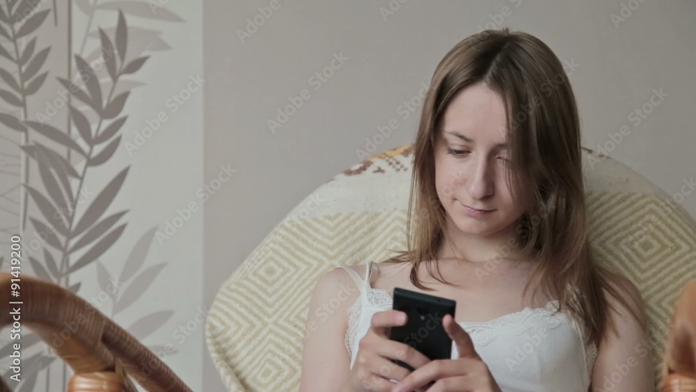 Young beautiful woman sitting with smart phone. Young beautiful woman sitting with smart phone.