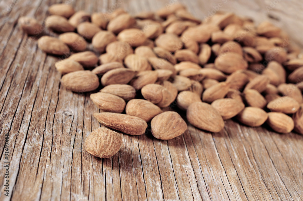 shelled almonds on a wooden table shelled almonds on a wooden table