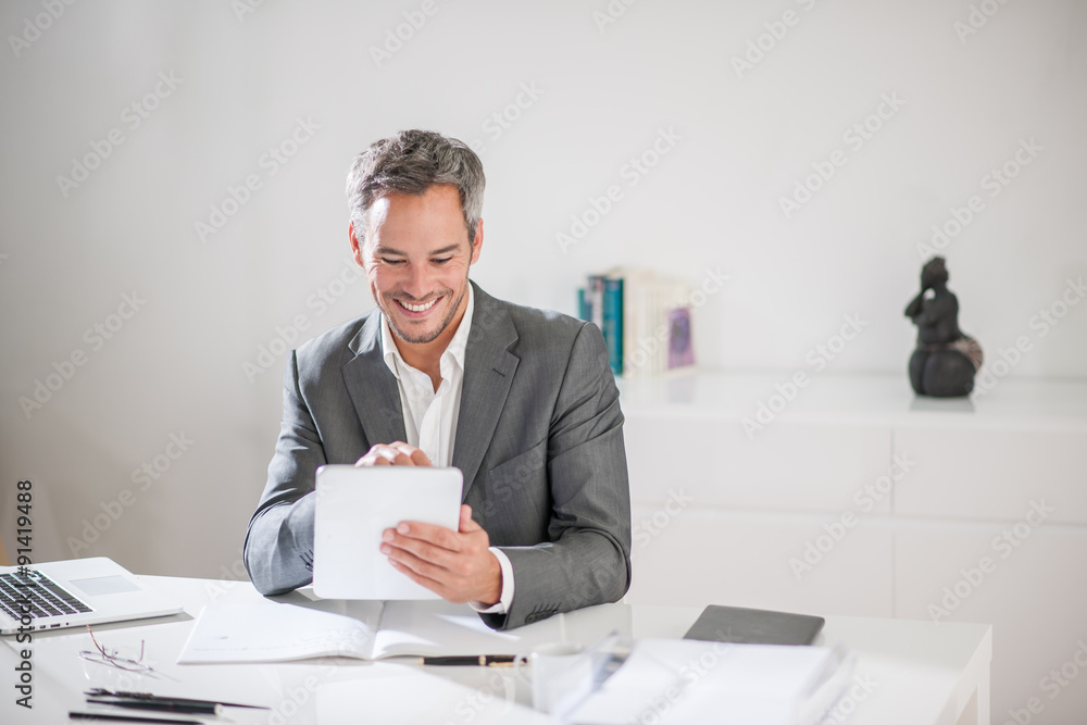 Portrait of a grey hair businessman and beard working on his ta Portrait of a grey hair businessman and beard working on his ta