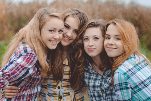 Four happy smiling amazing teenage girls having fun together