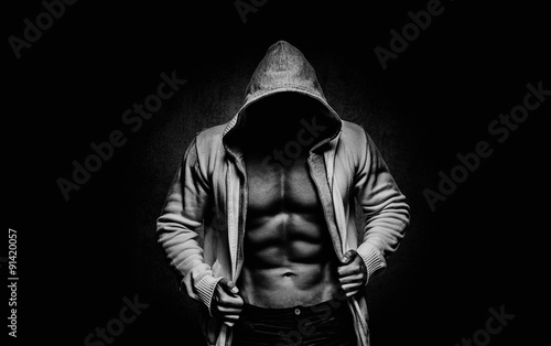 strong athletic man on black background