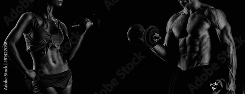 strong young couple working out with dumbbells. Shot in studio o © romanolebedev