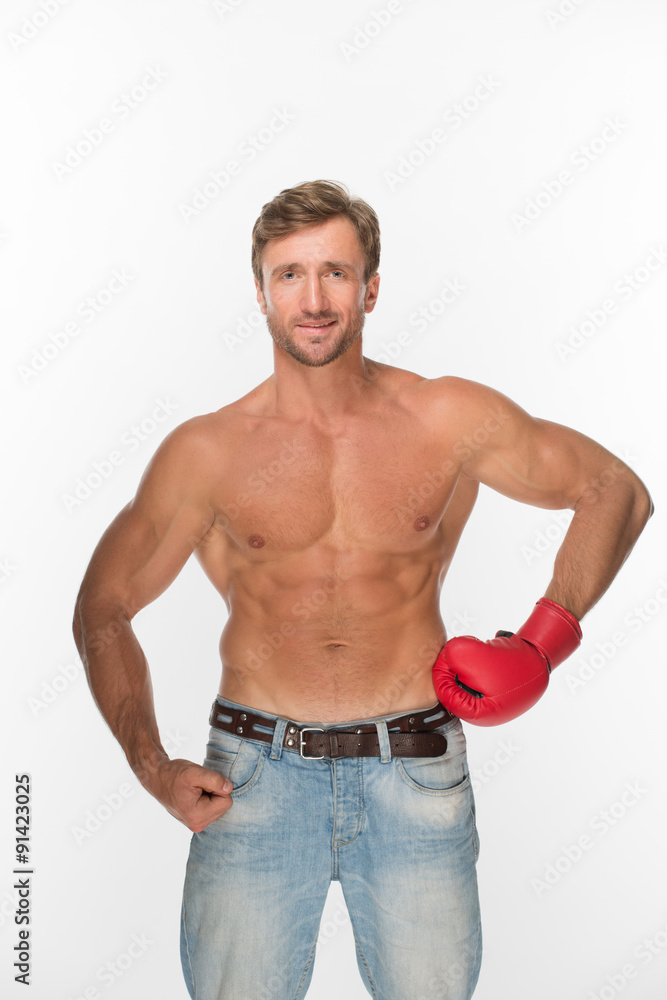 Shirtless man with a boxing glove over white Shirtless man with a boxing glove over white