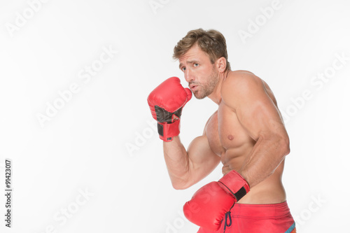 Boxer fighter in red boxing gloves © Svyatoslav Lypynskyy