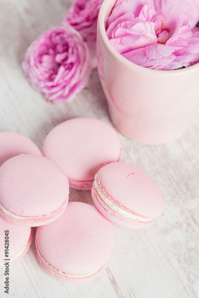 Tea cup with rose and pink macaroons Tea cup with rose and pink macaroons