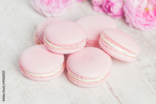 Pastel pink macaroons with rose, selective focus