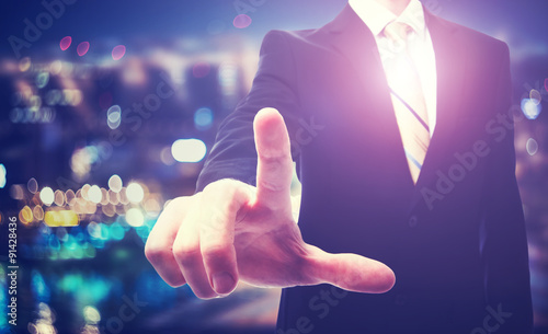 Businessman pointing to something on a blurred background