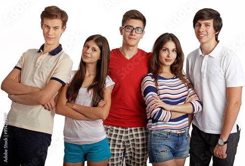 Portrait of stylish team of classmates posing in studio over white background. Diversity of handsome Caucasian people in casual clothes smiling looking at camera. Teamwork, college, education concept.