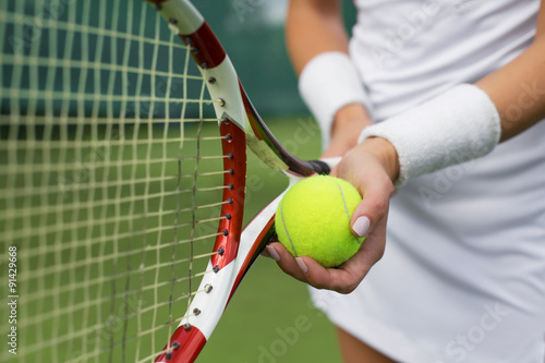 Photography Tennis player holding racket and ball in hands