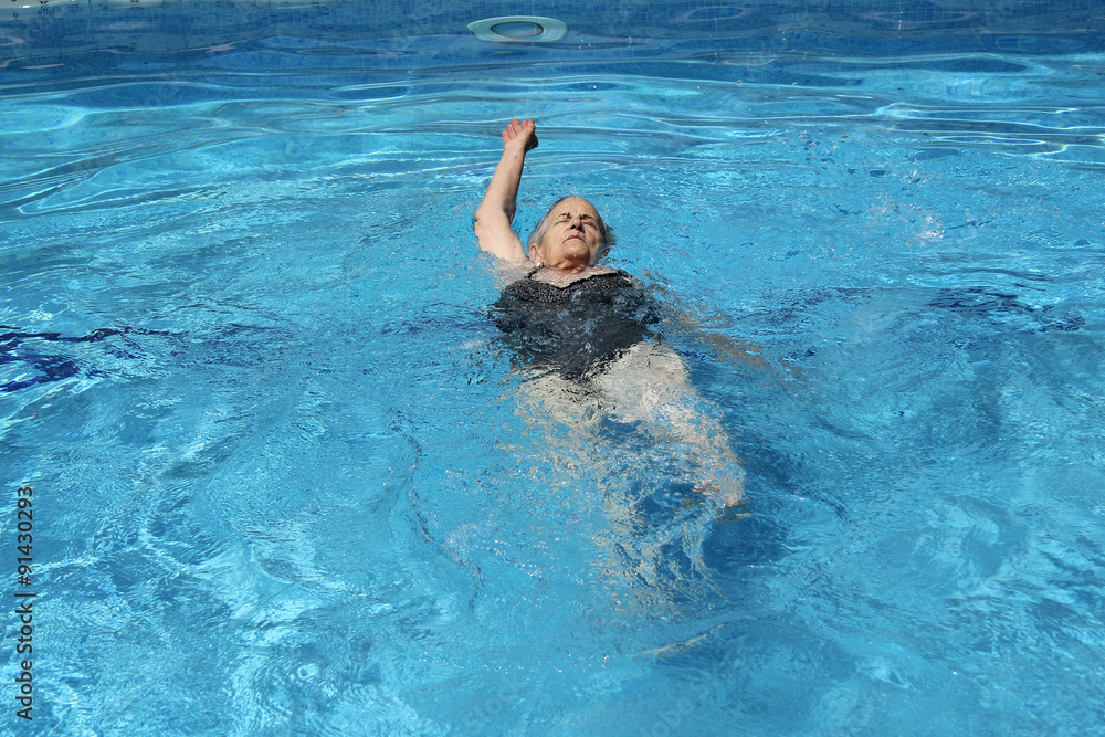 Senior Woman Having Fun In Swimming Pool