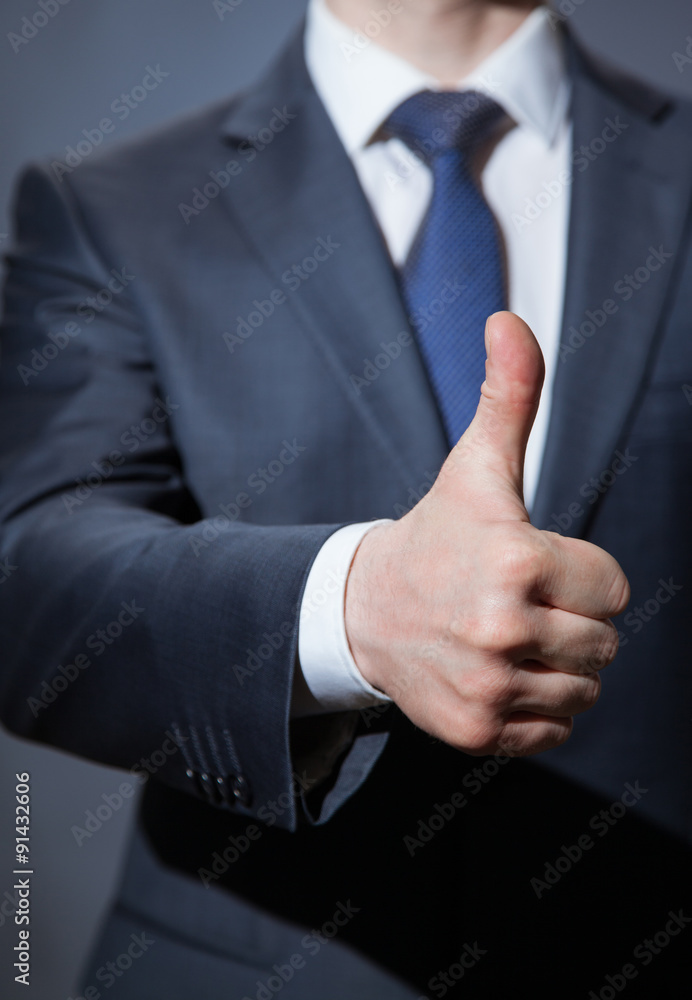 Unrecognizable businessman showing thumb up Unrecognizable businessman showing thumb up