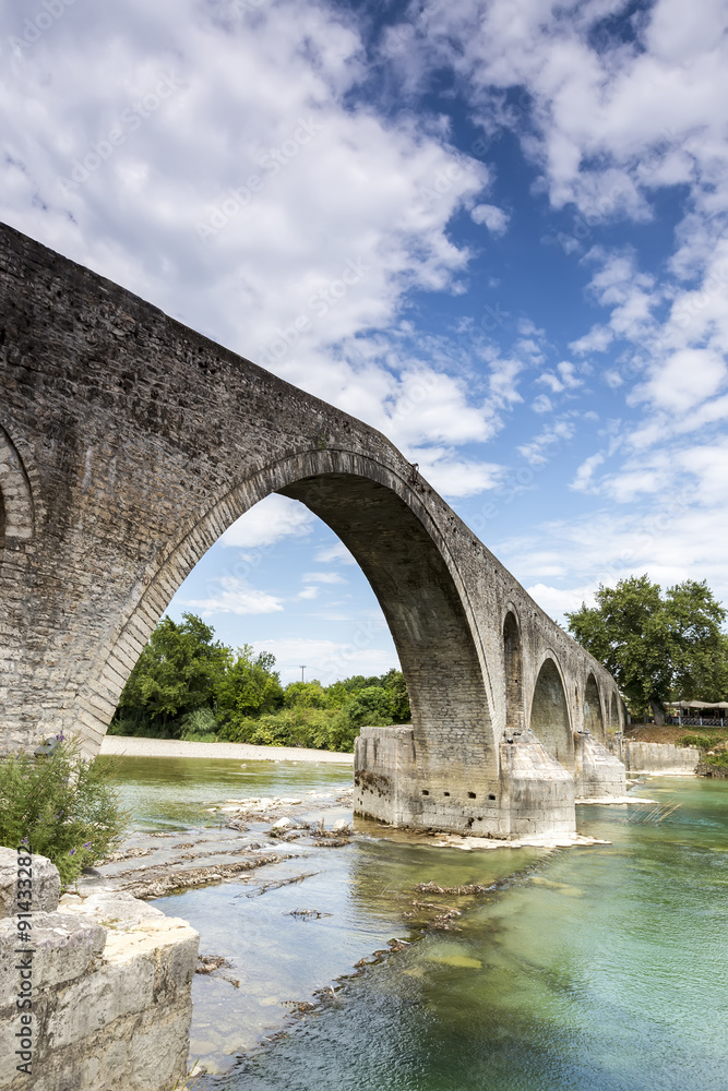 Fototapeta premium The Bridge of Arta is an old stone bridge that crosses the Arach