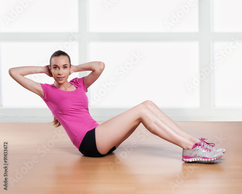 one woman exercising crunches fitness workout arms behind head