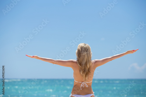 Woman enjoying summer by the ocean