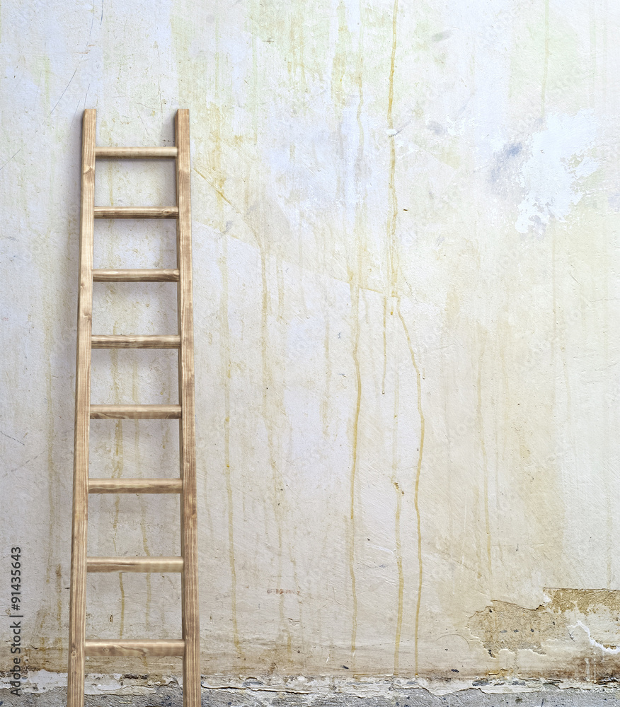 weathered stucco wall with wooden ladder