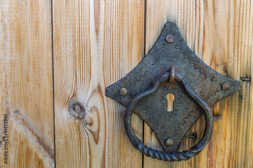 Old rusty doorknob and wood door