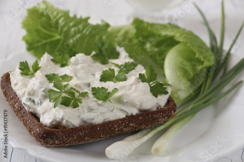 Sandwich with cottage cheese and herbs closeup