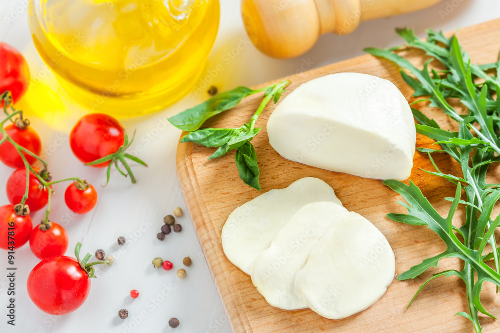 Cooking of salad with mozzarella and tomatoes, top view Cooking of salad with mozzarella and tomatoes, top view