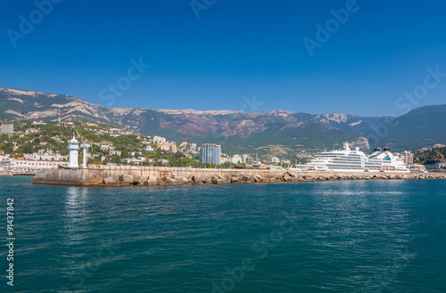 Fototapeta Naklejka Na Ścianę i Meble -  Big ship evening sailing off from Yalta port