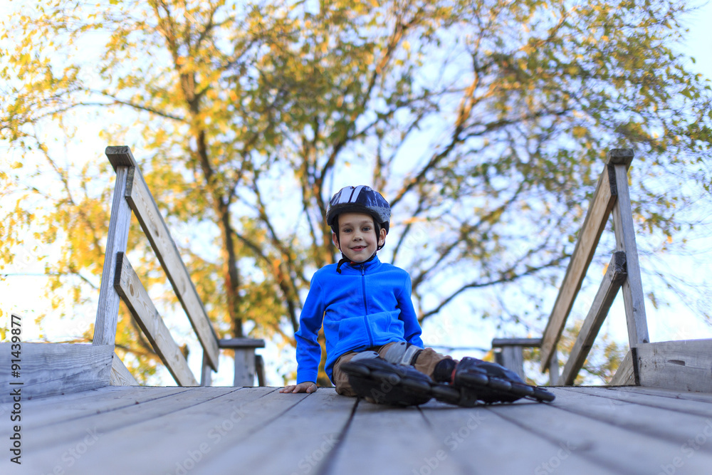 custom made wallpaper toronto digitalrelaxation after roller skating. happy tired boy sitting on a wooden bridge resting after rollerblading