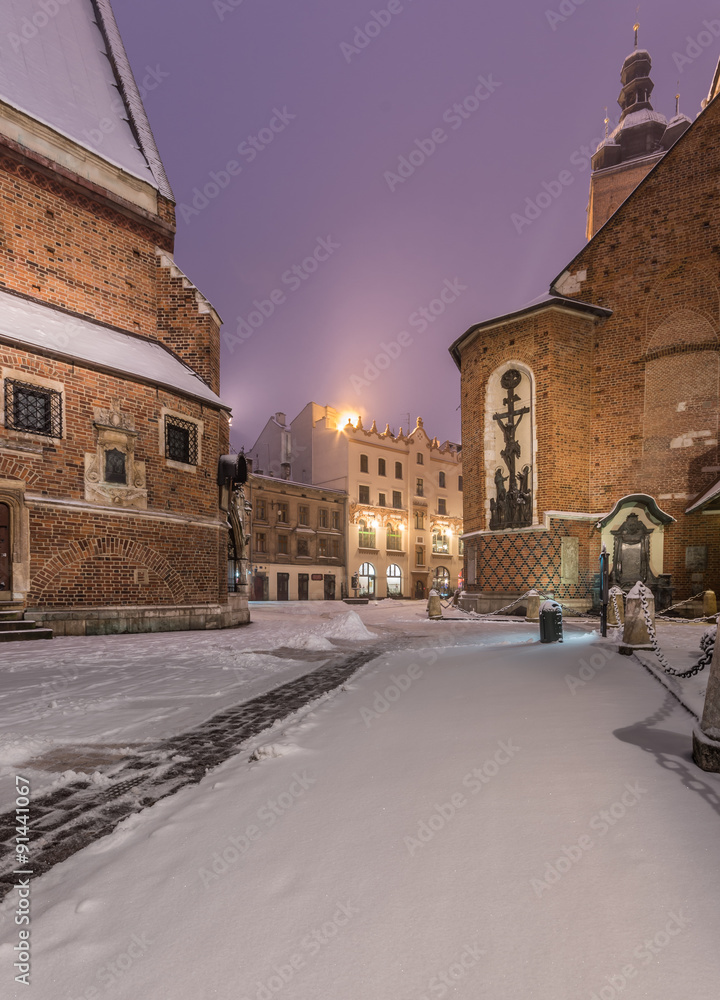 Krakow, Poland, Mariacki square between St Mary's church and St Barbara's church in winter
