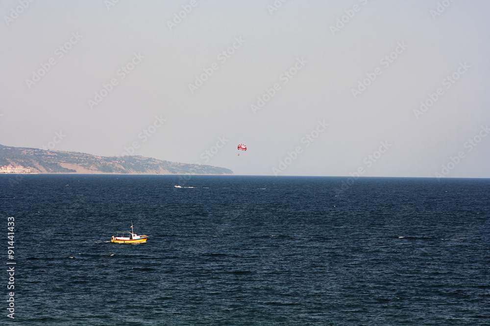 Parasailing with a boat over the sea