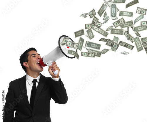 Fotografía Businessman yelling into a megaphone with money coming out of it