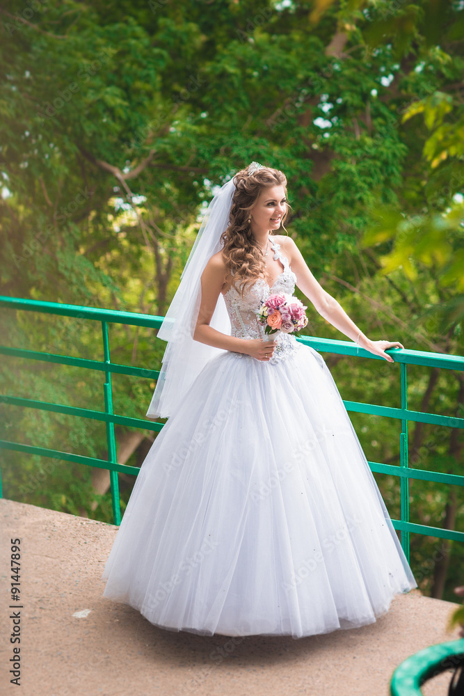 beautiful happy stylish bride  on the background of nature