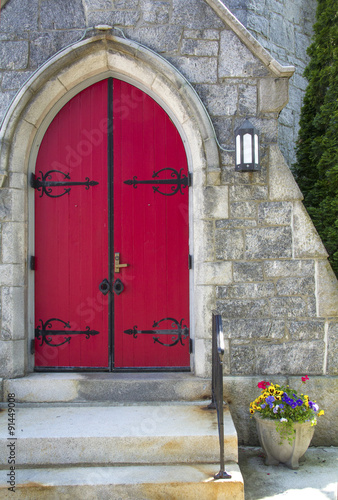Red doorway, flowers in pot, church, downtown Keene, New Hampshi
