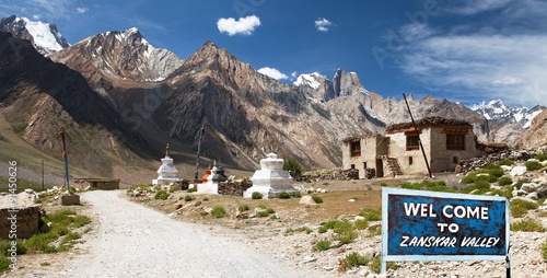 Village in Suru valley and signpost Welcome to Zanskar photo