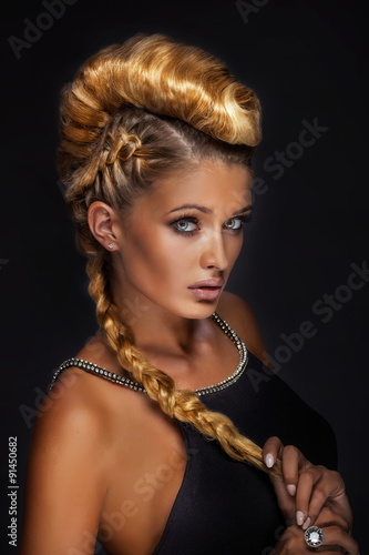 Portrait of blonde lady in creative hair.