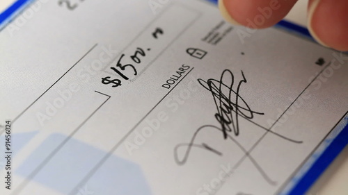 writing and signing a check for a large amount