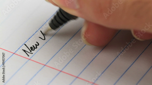 writing down your new years resolutions on paper - different angle